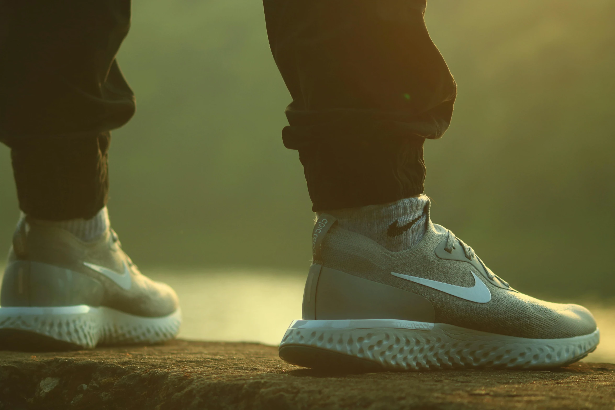 a person standing on top of a rock next to a body of water, inspired by Mike Winkelmann, pexels contest winner, hyperrealism, futuristic sneakers, soft light from the side, sneaker made out of lego, walking upright in a forest