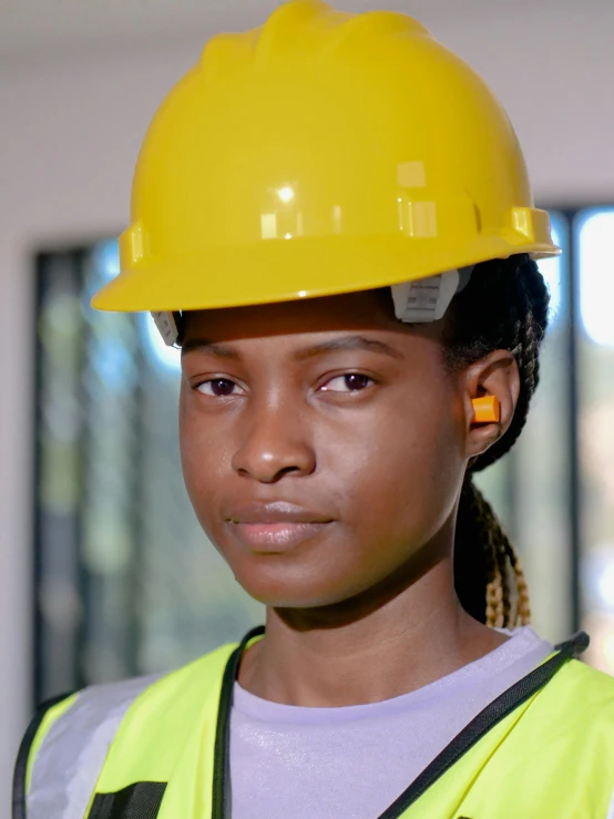 a close up of a person wearing a hard hat, by Afewerk Tekle, teenager girl, professional image, super focused, yellow cap
