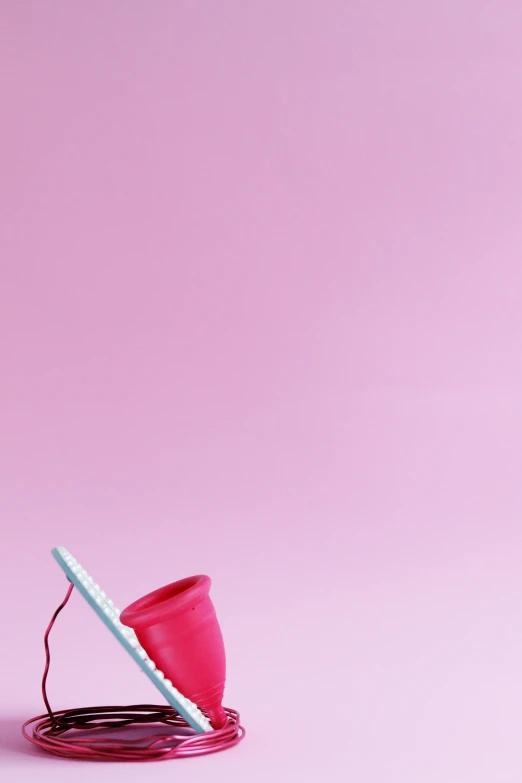 a pink cup sitting on top of a wire, by Doug Ohlson, conceptual art, telephone, toy commercial photo, art print, dunce