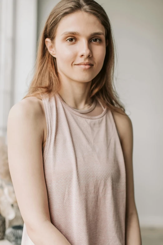 a woman sitting on a couch next to a teddy bear, by Maud Naftel, trending on pexels, wearing tank top, headshot half figure, light blush, organic dress