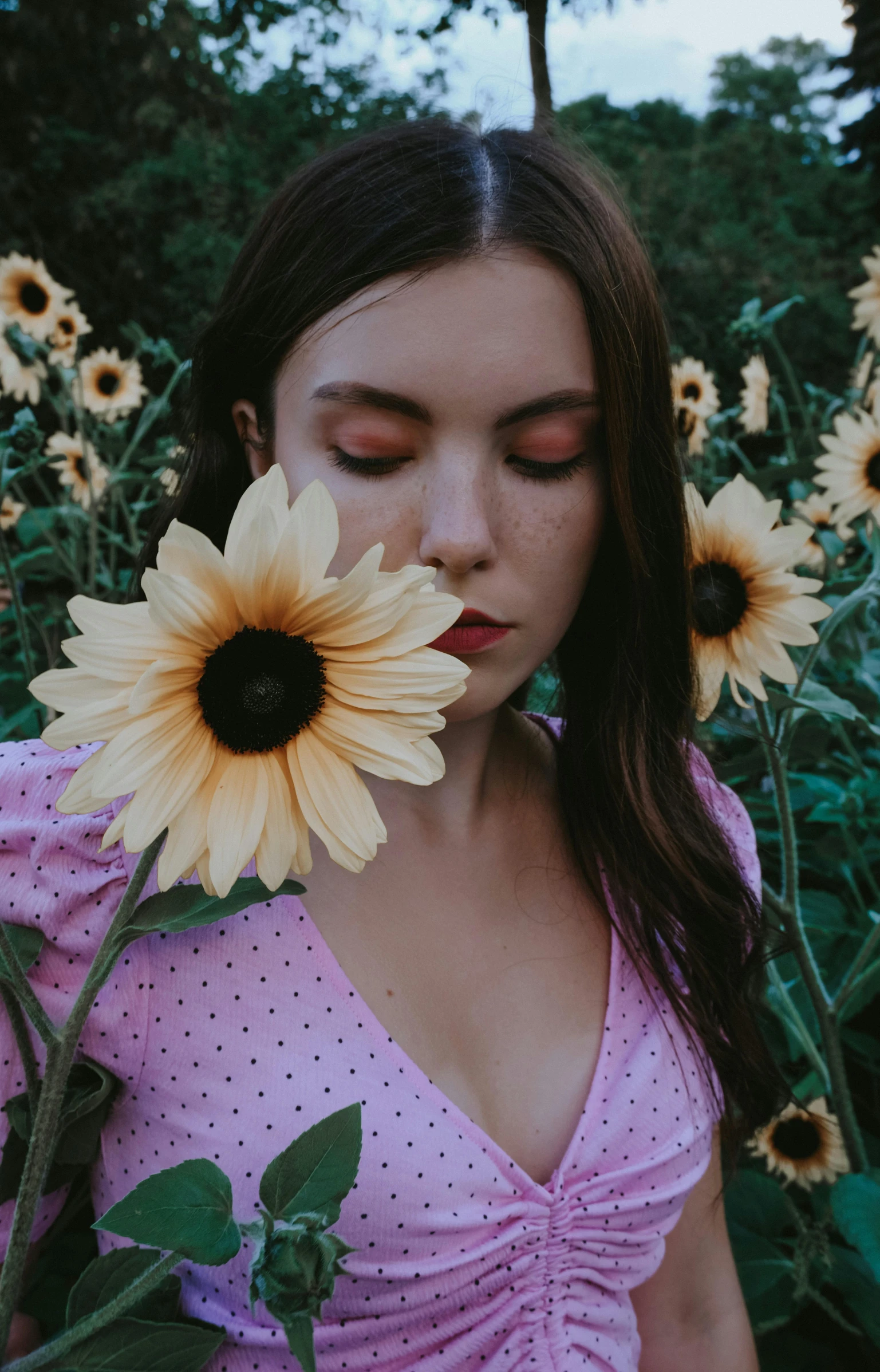 a woman standing in a field of sunflowers, inspired by Elsa Bleda, aestheticism, soft freckles, trending on vsco, eyes half closed, portrait sophie mudd