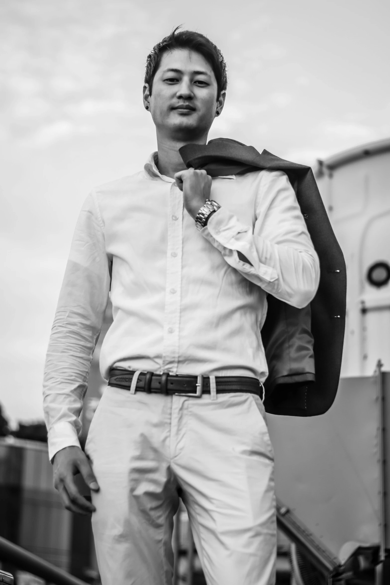 a black and white photo of a man with a jacket, inspired by Harry Haenigsen, pexels contest winner, wearing a white button up shirt, in pilote, lifestyle, young man with short