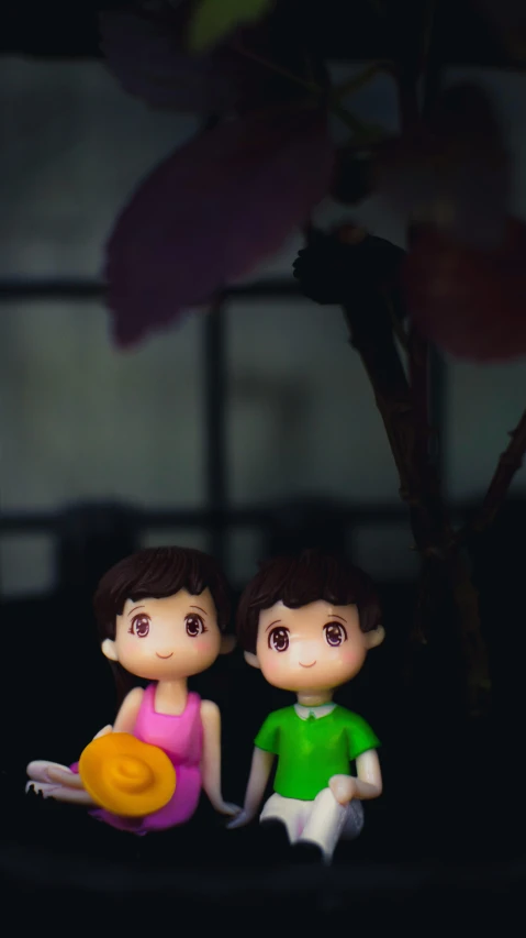 a couple of figurines sitting next to each other, a picture, inspired by Nara Yoshitomo, pexels, green and pink, evening time, gif, shot on sony a 7