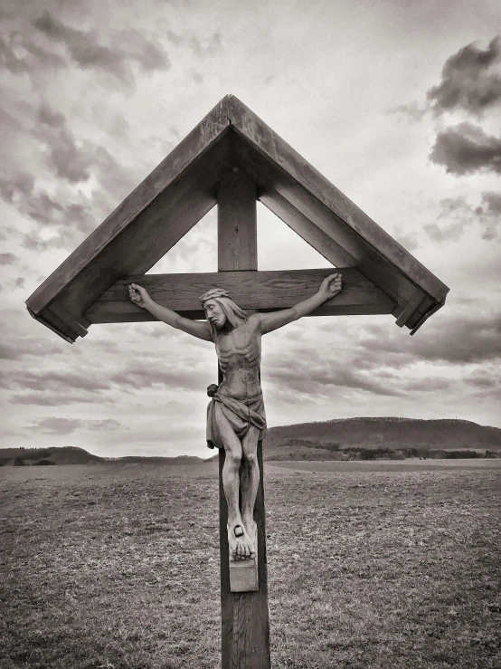 a black and white photo of jesus on the cross, a black and white photo, by Gyula Basch, lachlan bailey, hasselblad photograph, a wooden, wide angle landscape photography