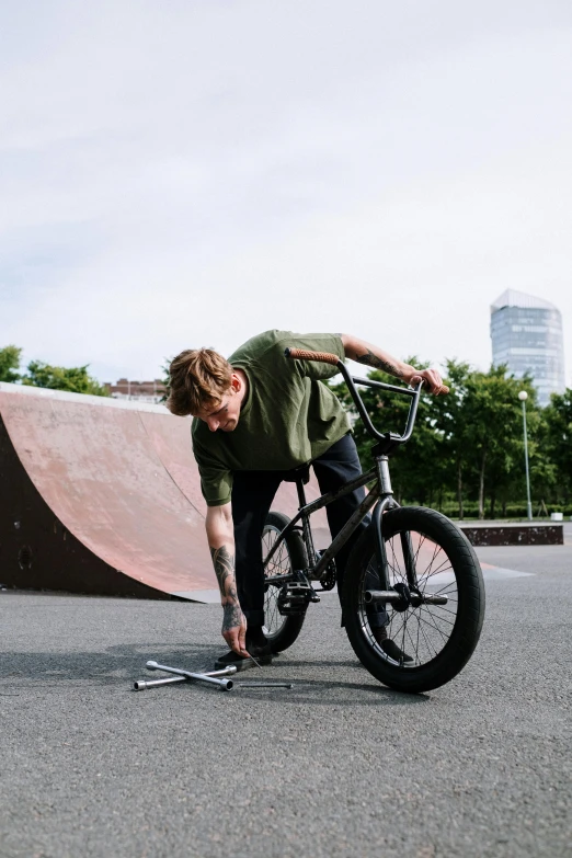 a man riding a bike up the side of a ramp, inspired by Seb McKinnon, pexels contest winner, park in background, crushed, square, boys