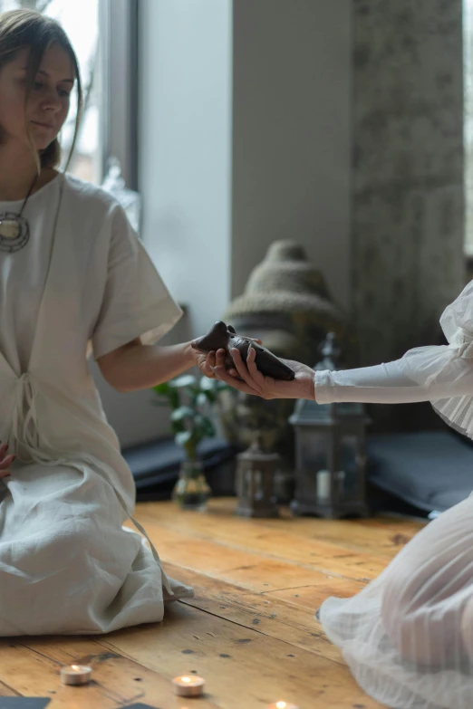 a couple of women sitting on top of a wooden floor, inspired by Pietro Longhi, unsplash, renaissance, tea ceremony scene, still from a live action movie, white, apothecary