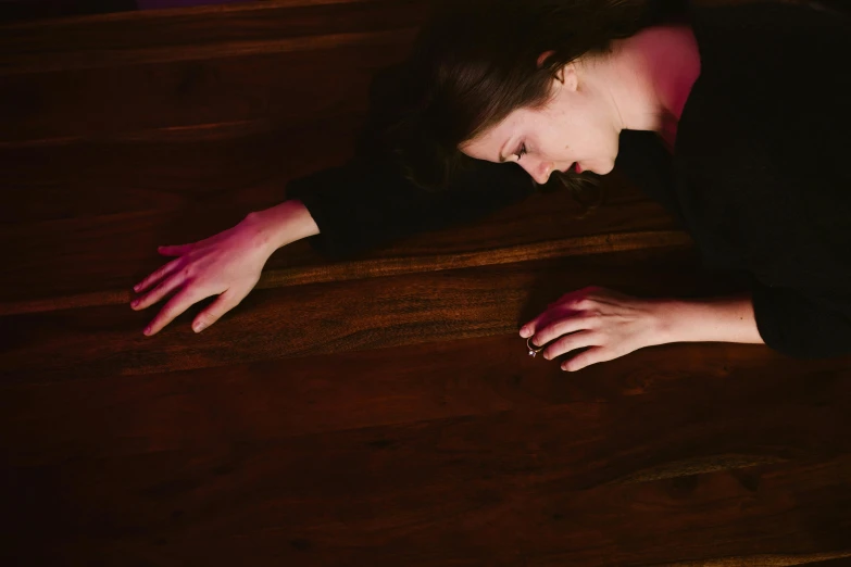 a woman laying on top of a wooden floor, by Arabella Rankin, unsplash, renaissance, portrait of mournful, thrown tables, 15081959 21121991 01012000 4k, performing