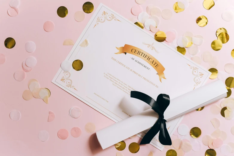 a diploma on a pink background with confetti, by Julia Pishtar, private press, high quality paper, golden ribbon, thumbnail, single