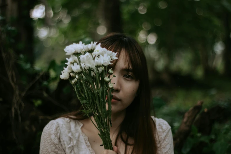 a woman holding a bunch of white flowers, inspired by Elsa Bleda, pexels contest winner, portrait of a japanese teen, concerned, forest fae, with a white