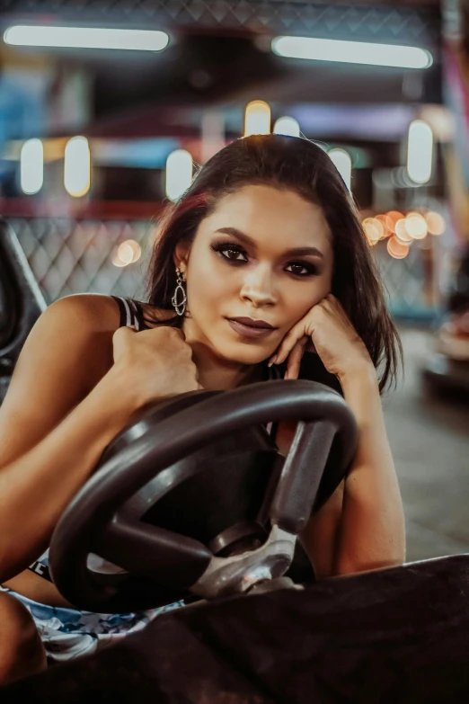 a woman sitting in the driver's seat of a car, trending on pexels, renaissance, “zendaya, on a street race track, malaysian, non binary model