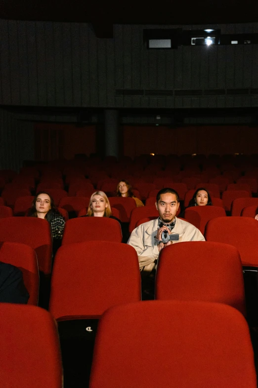 a group of people sitting in a movie theater, julia hetta, adult swim, sangsoo jeong, [ theatrical ]