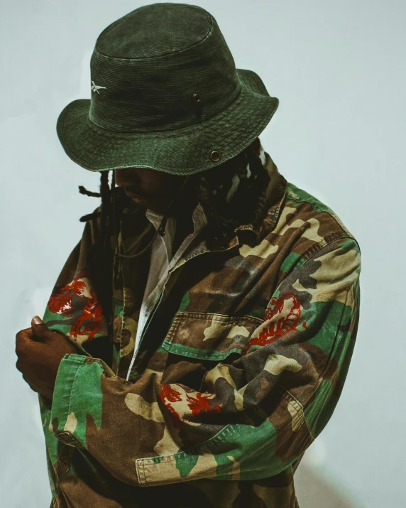 a close up of a person wearing a hat, an album cover, unsplash, camouflage uniform, full body photo, ((zerator))
