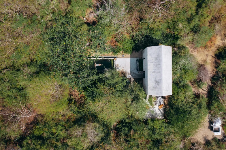 an aerial view of a house in the woods, a portrait, unsplash contest winner, conceptual art, dwell, concrete housing, 2000s photo, ignacio fernandez rios ”