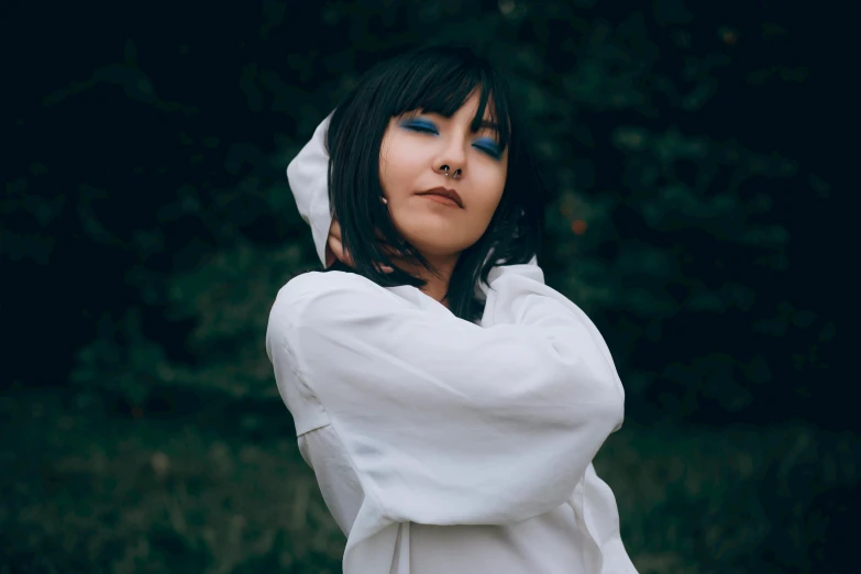 a woman in a white shirt posing for a picture, an album cover, inspired by Leng Mei, unsplash, black haired girl wearing hoodie, whitebangs, blue, lily frank