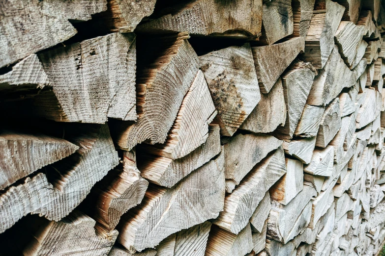 a pile of wood stacked on top of each other, by Tom Wänerstrand, unsplash, auto-destructive art, instagram post, grey, warm, woodfired