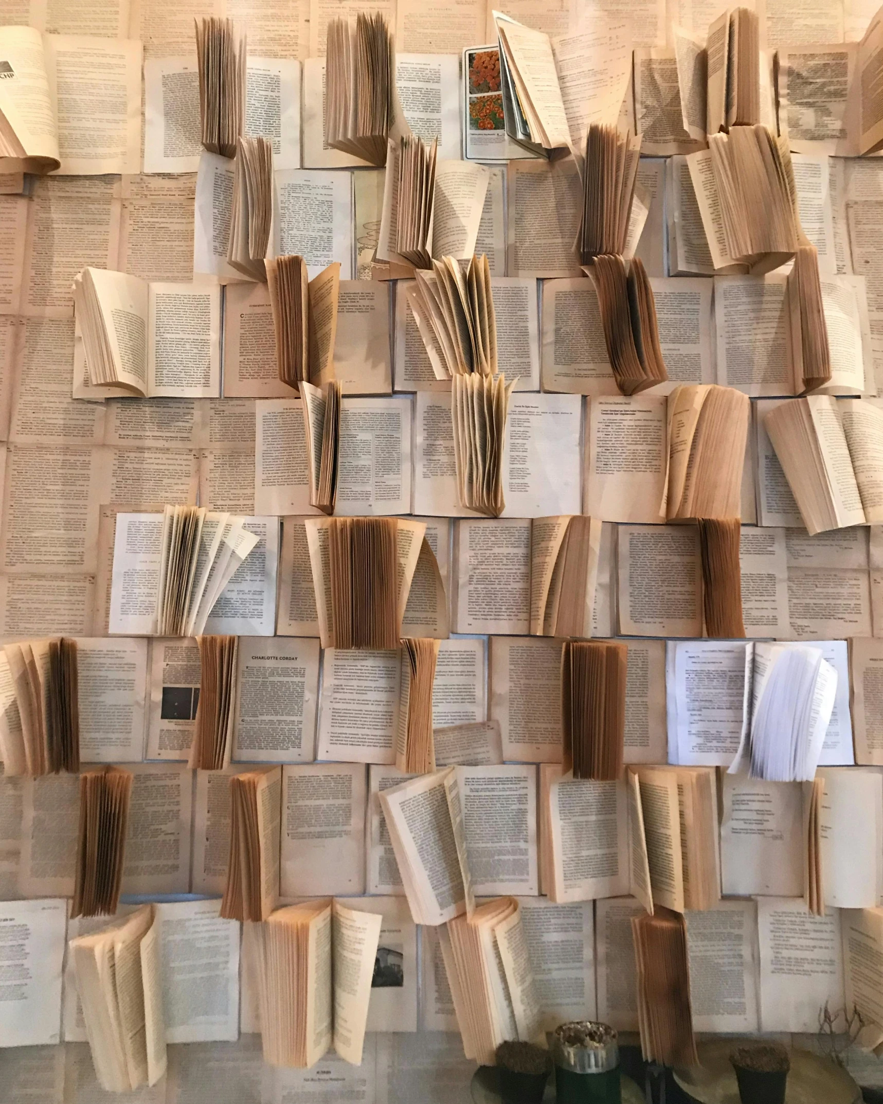 a pile of books sitting on top of a table, a gigantic wall, paper cutout, tumblr aesthetic, multiple stories