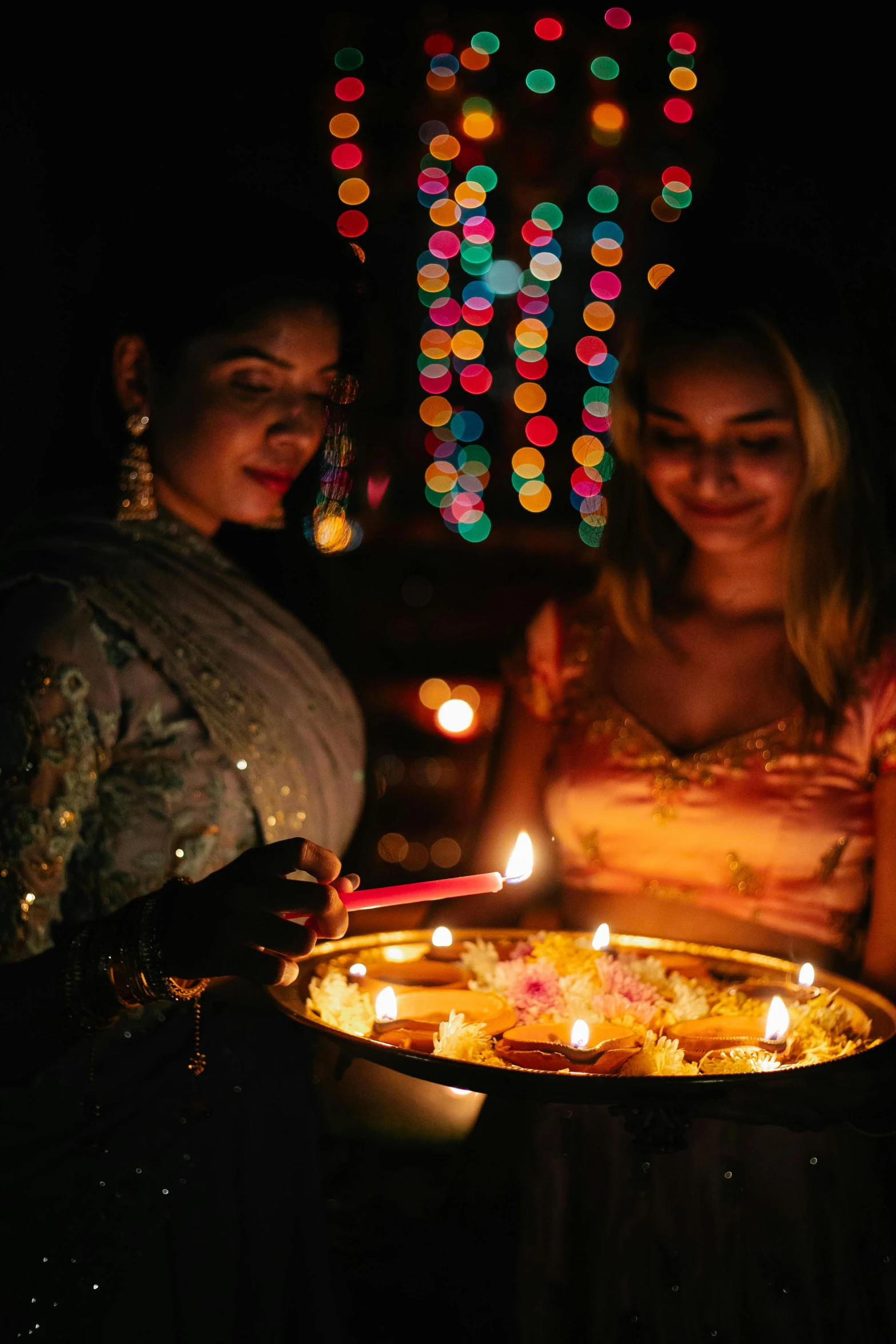 a group of women standing next to each other holding candles, pexels, visual art, standing in a hindu kovil, partylights, offering a plate of food, gif