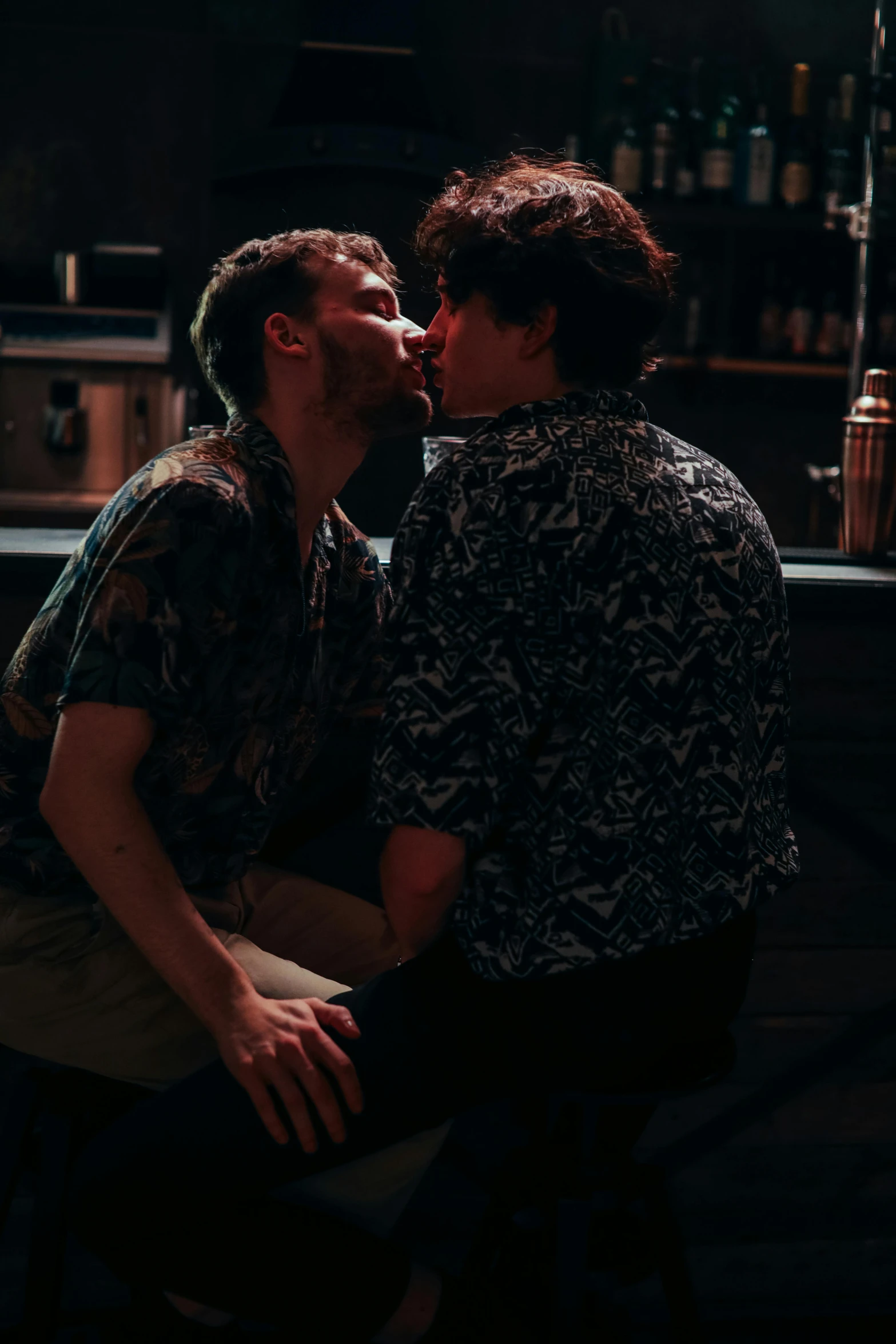 a couple of men sitting next to each other at a bar, by Jessie Alexandra Dick, pexels, lesbian kiss, patterned, actors, ignant