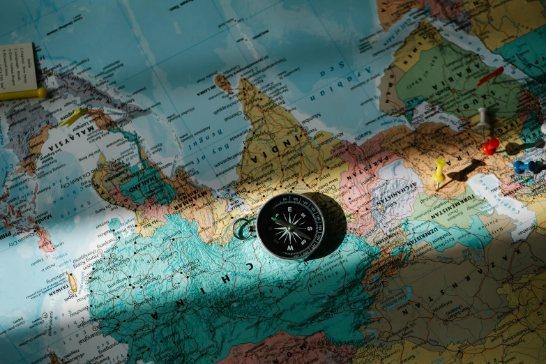 a compass sitting on top of a map, a digital rendering, by Adam Marczyński, pexels, regionalism, sanctions in russia, avatar image, conde nast traveler photo, photo of the middle of the ocean