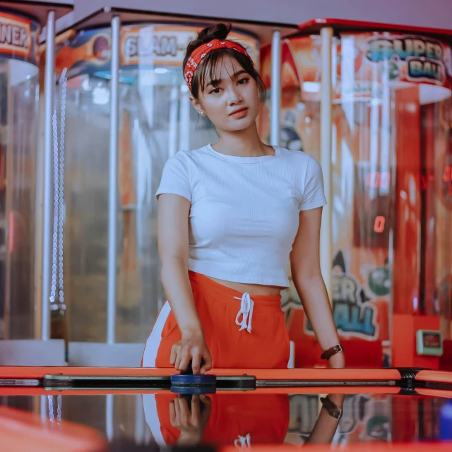 a woman standing next to a pool table, pexels contest winner, young cute wan asian face, arcade game, red and white color theme, white and orange