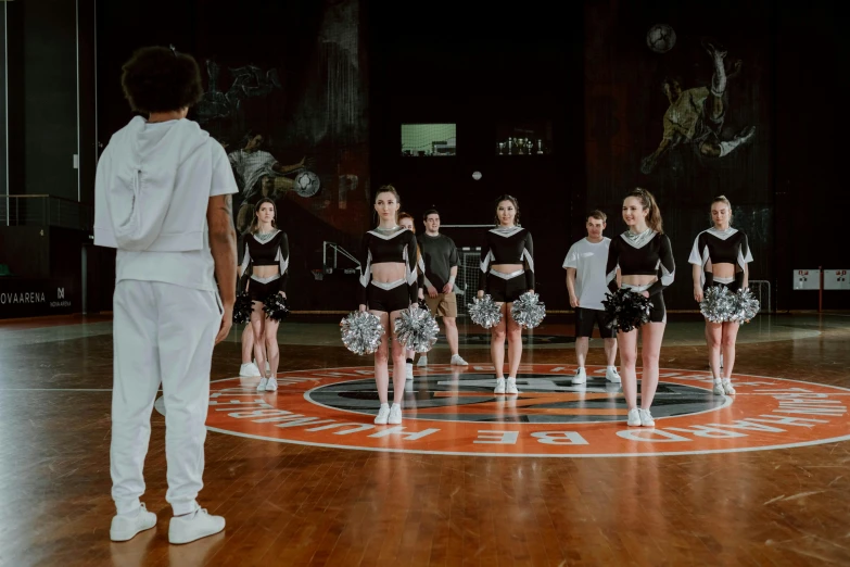 a group of young people standing on top of a basketball court, pexels contest winner, antipodeans, white uniform, performing a music video, pitchburn devils, ( ( theatrical ) )