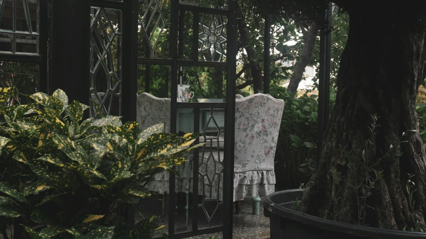 a dress hanging out of a window next to a potted plant, unsplash, rococo, assam tea garden setting, gazebos, grey, armchairs