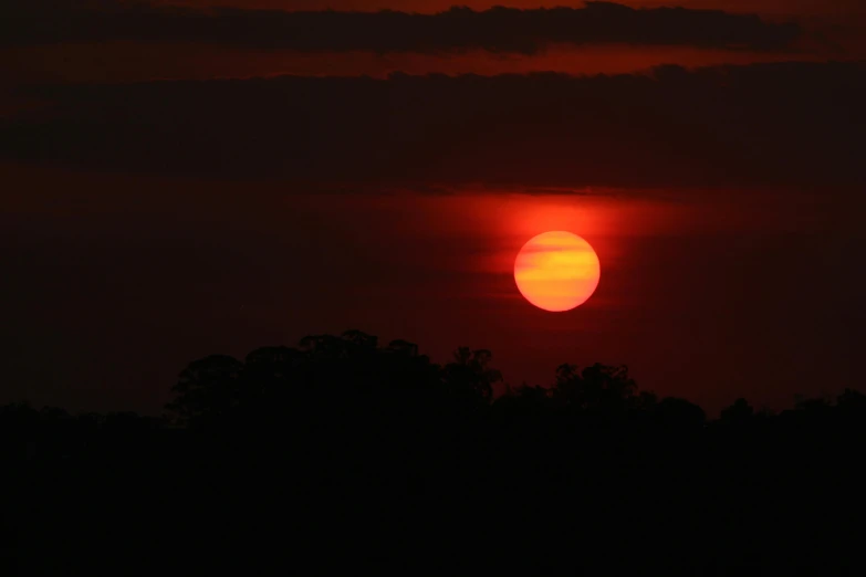 the sun is setting in the dark sky, a picture, by Ian Fairweather, digital yellow red sun, hot weather, 200mm wide shot, landscape photo