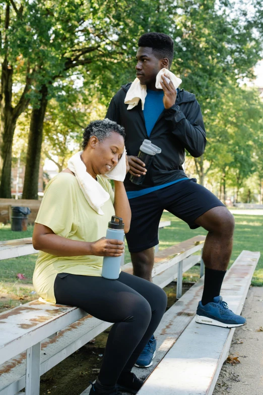 a couple of people that are sitting on a bench, hydration, sweat drops, black man, struggling