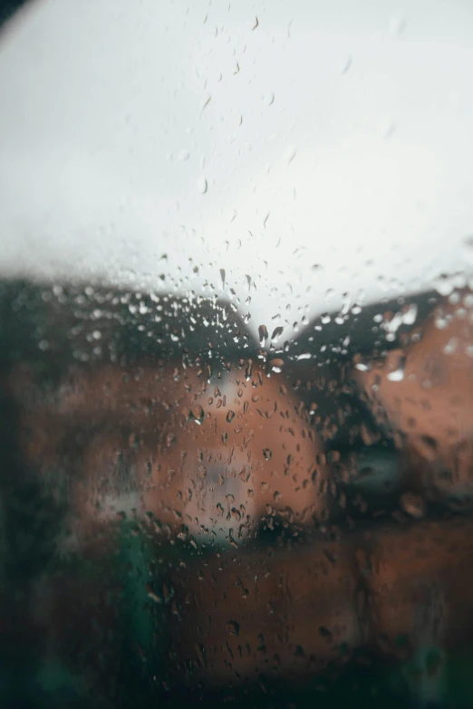 a close up of a window with rain on it, inspired by Elsa Bleda, trending on unsplash, wet reflections in square eyes, hazy and dreary, battered, rain sensor