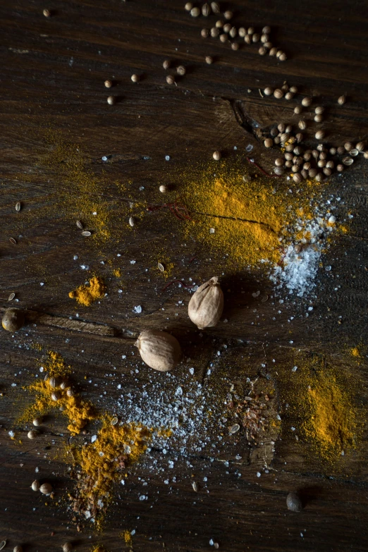 a wooden table topped with nuts and spices, a portrait, trending on unsplash, renaissance, flour dust spray, yellow, thumbnail, 8l