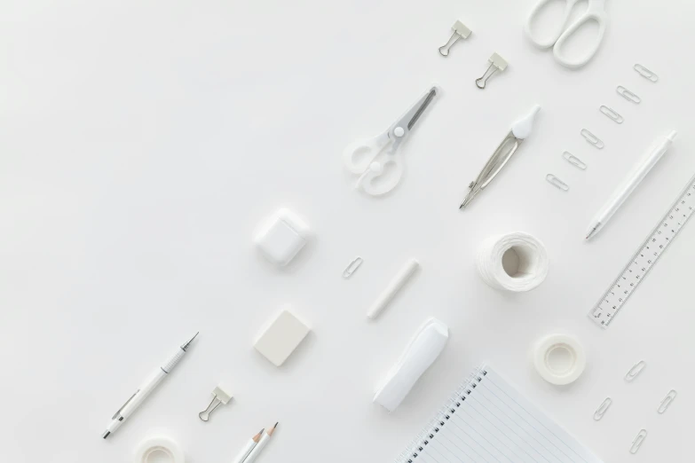 various office supplies laid out on a white surface, trending on pexels, minimalism, all white, intricate detail, surgical implements, behance lemanoosh