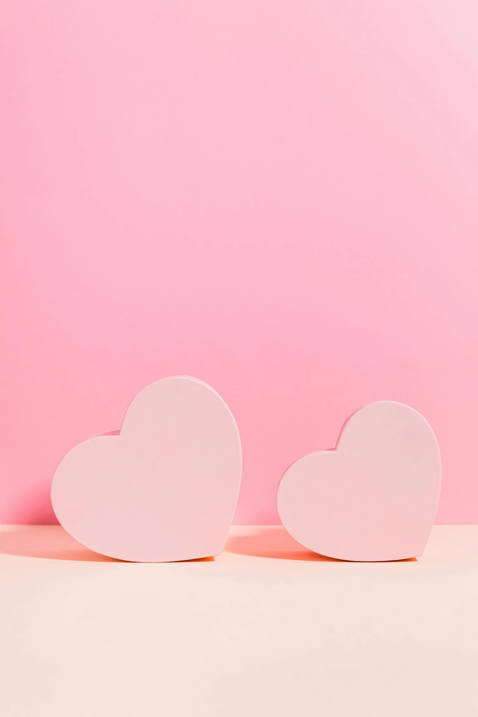 two pink hearts on a pink background, by Julia Pishtar, commercial photo, ((pink)), small, uk