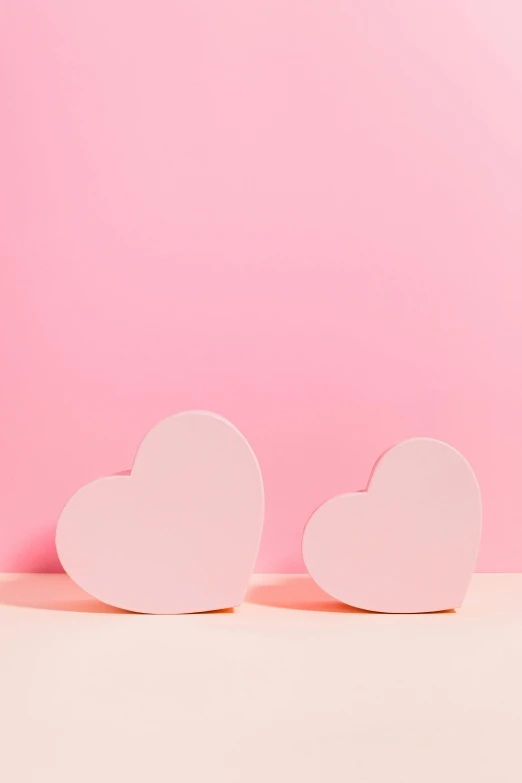 two pink hearts on a pink background, by Julia Pishtar, commercial photo, ((pink)), small, uk