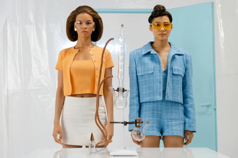 a couple of women standing next to each other, trending on pexels, renaissance, futuristic chemistry lab, slow motion fashion, glass and gold pipes, ashteroth