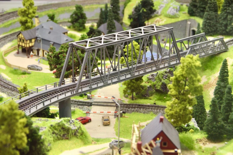 a model train crossing a bridge over a river, figuration libre, countryside city scene, truss building, instagram post, ultra-high details