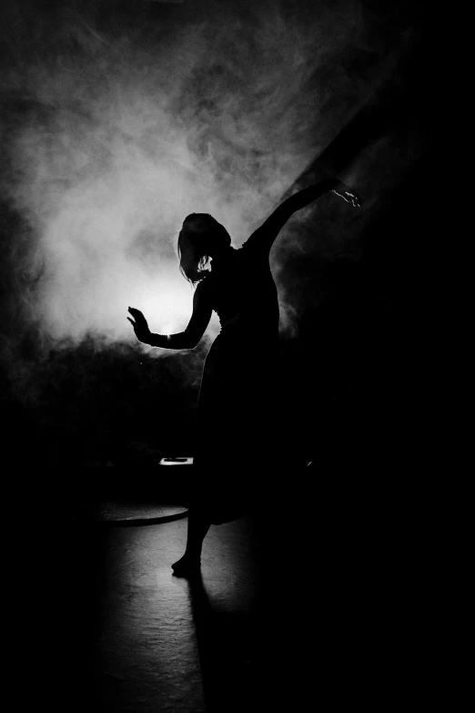 a black and white photo of a woman dancing, flickr, smoky lighting, silhouette :7, dark!