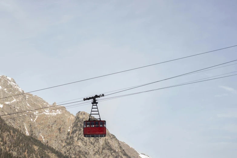 a cable car going up the side of a mountain, by Peter Churcher, pexels contest winner, figuration libre, maroon, winter, wyoming, high quality product image”