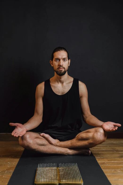 a man sitting on top of a yoga mat, a portrait, by Nina Hamnett, unsplash, renaissance, frontal pose, dan eder, no - text no - logo, focused photo