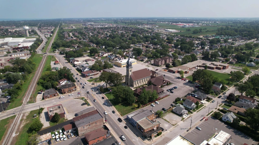 an aerial view of a city with a clock tower, by Joe Stefanelli, midwest town, gigapixel photo, church, brown