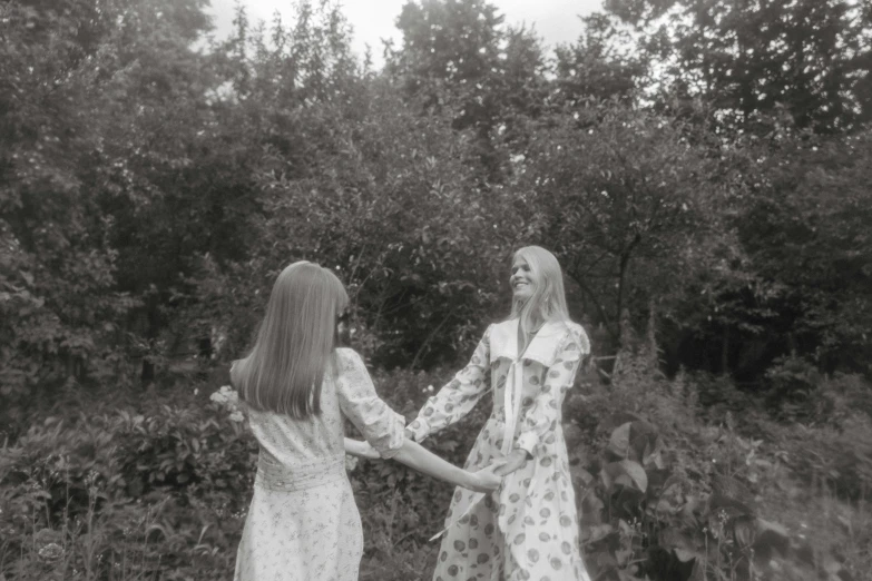 a couple of women standing next to each other in a field, inspired by Diane Arbus, tumblr, romanticism, midsommar, paisley, hands, 7 0 s cinestill