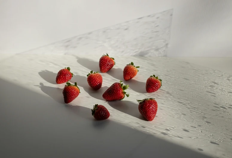 a bunch of strawberries sitting on top of a counter, unsplash, hyperrealism, taken on iphone 1 3 pro, minimalist photo, group of seven, bright daylight indoor photo