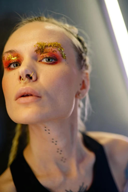 a woman with gold glitter on her eyes, trending on pexels, renaissance, die antwoord ( yolandi visser ), fiery palette, grim fashion model looking up, michael angelo inspired