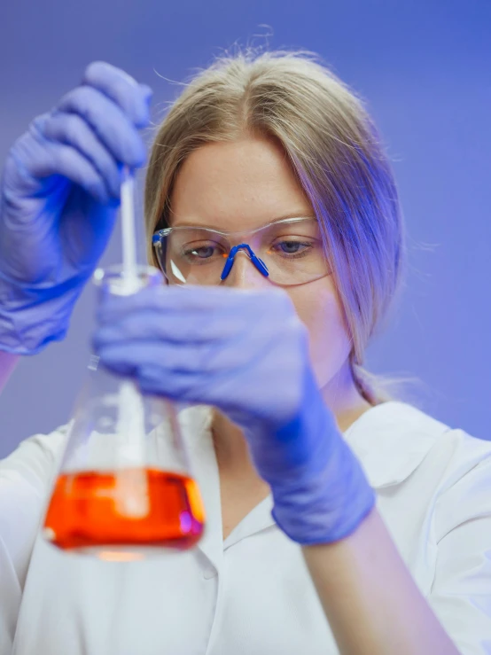 a woman in a lab coat holding a flask, shutterstock, analytical art, reddit post, strong blue and orange colors, college girls, 15081959 21121991 01012000 4k