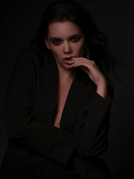 a woman in a black suit posing for a picture, an album cover, inspired by Peter Lindbergh, unsplash, kendall jenner, photography of todd hido, attractive woman, black on black