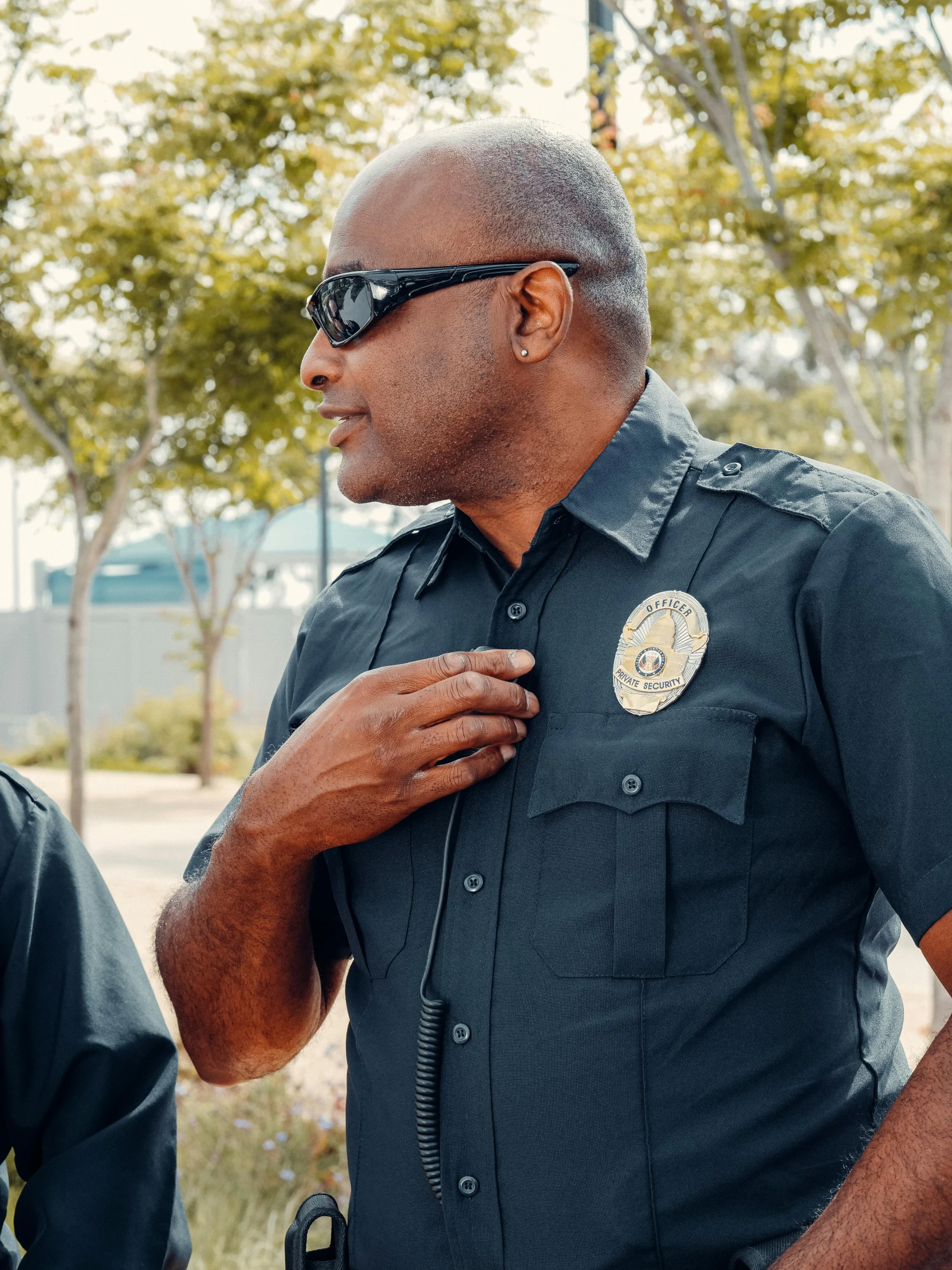 a couple of men standing next to each other, police uniform, profile image, focused photo, college