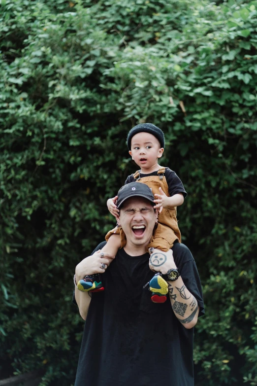 a man carrying a child on his shoulders, inspired by Eddie Mendoza, unsplash, portrait of chester bennington, pete davidson, an indonesian family portrait, toys
