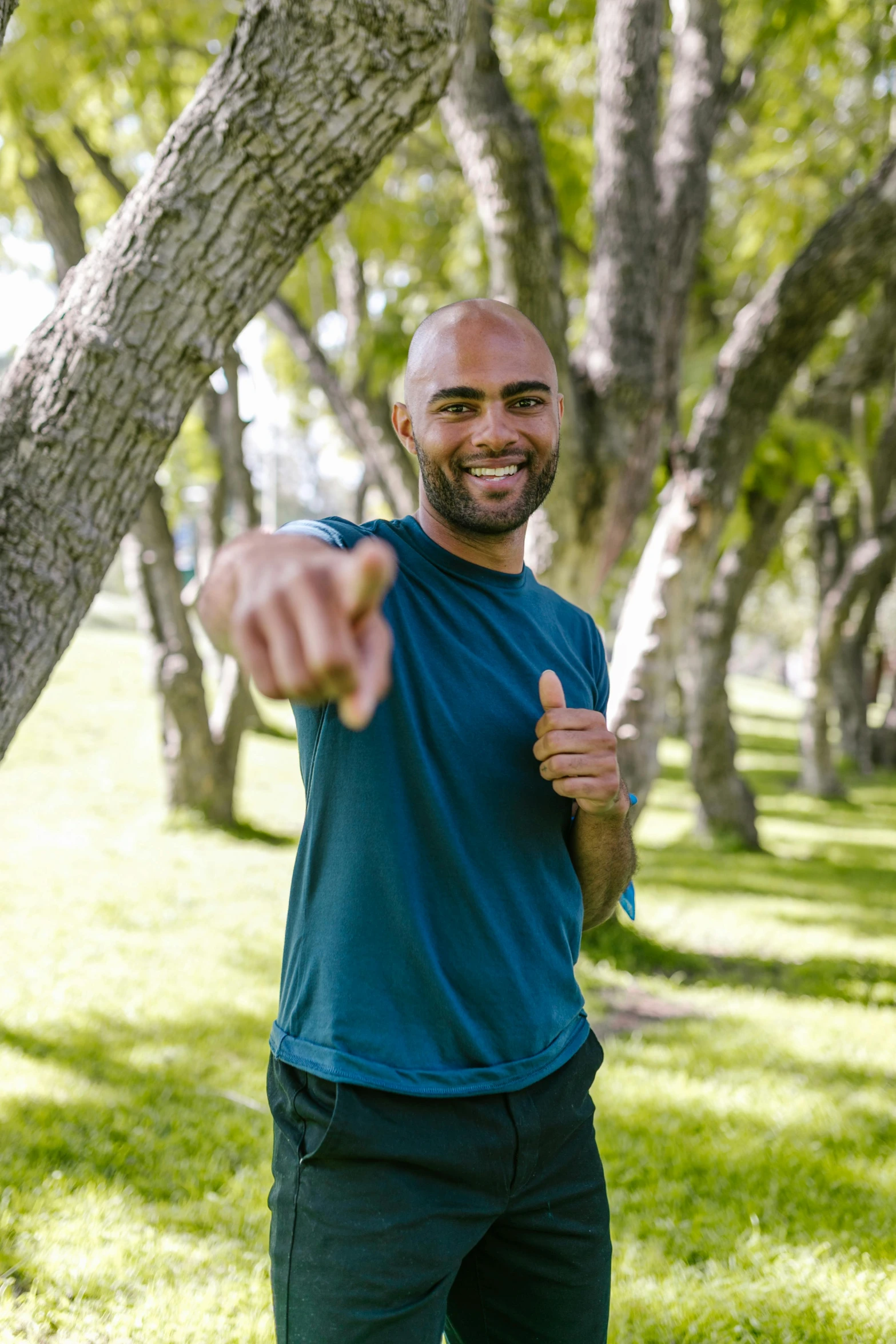 a man throwing a frisbee in a park, inspired by Víctor Manuel García Valdés, happening, giving a thumbs up to the camera, bald, avatar image, 3 2 - year - old