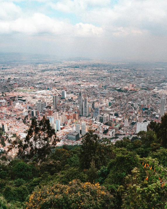 a view of a city from the top of a hill, by Alejandro Obregón, unsplash contest winner, monserrat gudiol, city of the jungle, 7 0 s photo, background image