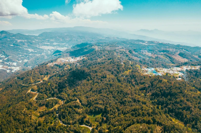 a view of the mountains from a plane, a tilt shift photo, by Alejandro Obregón, pexels contest winner, sumatraism, forest clearing landscape, 4 k cinematic panoramic view, thumbnail, marbella