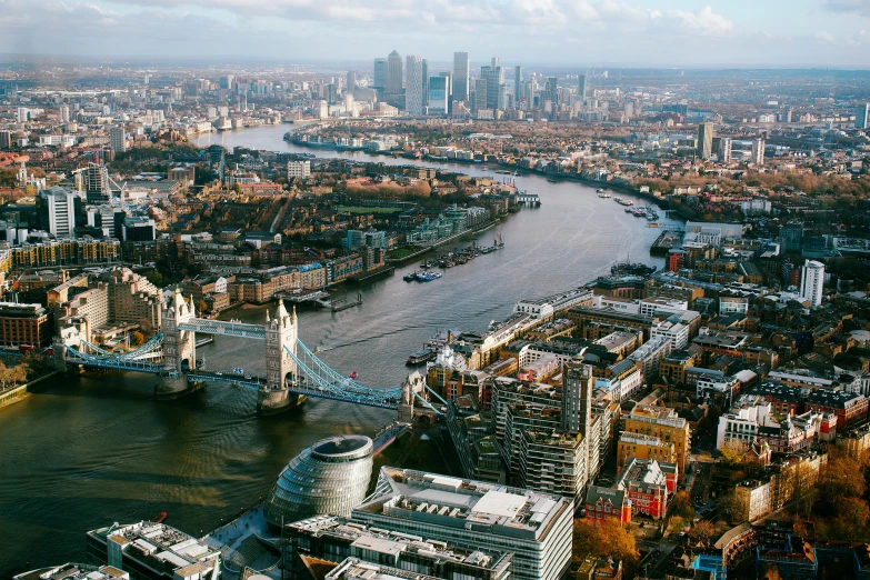 a river running through a city next to tall buildings, pexels contest winner, tower bridge, aerial view of a city, thumbnail, norman foster